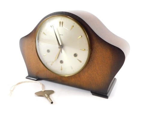 A Smith's oak cased mantel clock, the domed top above a silvered coloured dial, with gold point markers and hands, eight day chiming, 21cm high, 30cm wide, 12cm deep.