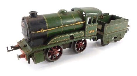 A tin plate clockwork train, in green LNER livery, number 5508, with carriage.