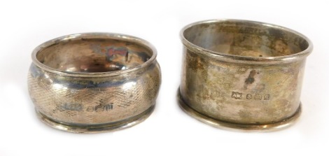 Two silver napkin rings, one with engine turned decoration, the other of plain design, ½oz. (2)