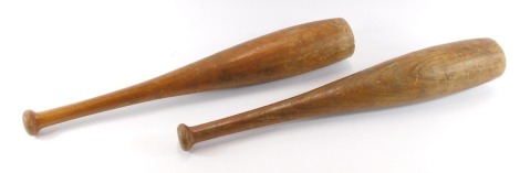 Two early 20thC wooden exercise clubs, each numbered 3, 59cm high.