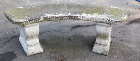 A cast concrete garden bench, curved on scroll supports, 40cm high, 110cm wide, 43cm deep.