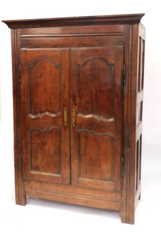 A 19thC Continental mahogany armoire, the top with moulded cornice above reeded column support, and two panelled doors, with two arched sections and brass key plates, 196cm high, 128cm wide, 57cm deep.