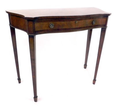 A mahogany and yew side table, the serpentine and fronted top of two panel detailing set with one long drawer, on tapered legs terminating in castors, 103cm wide, 46cm deep, 84cm high.