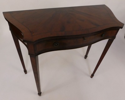 A mahogany and yew side table, the serpentine and fronted top of two panel detailing set with one long drawer, on tapered legs terminating in castors, 103cm wide, 46cm deep, 84cm high. - 2