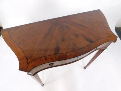 A mahogany and yew side table, the serpentine and fronted top of two panel detailing set with one long drawer, on tapered legs terminating in castors, 103cm wide, 46cm deep, 84cm high. - 3