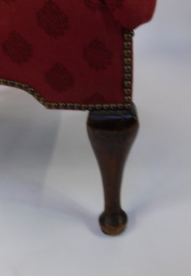 A late 19thC wingback armchair, with studded detailing on a red pattern fabric with out splayed arms on mahogany pad feet, 122cm high, 90cm wide, 56cm deep. - 3