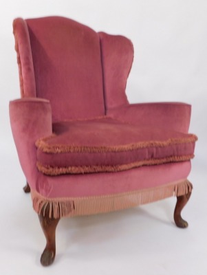 An early 20thC wingback armchair, in George III style, pink draylon upholstery with tassle ends, 105cm high, 89cm wide, 70cm deep. - 2