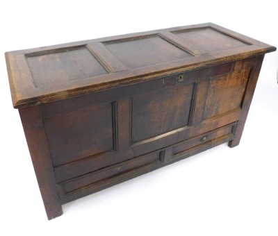 An 18thC oak mule chest, the three panelled top and front above two drawers on stiles, 75cm high, 131cm wide, 47cm deep.