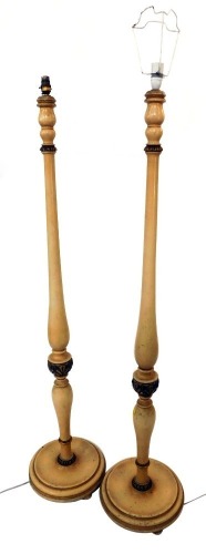 A pair of painted French style standard lamps, each cream painted with gilt highlights, on a circular foot, 155cm high.