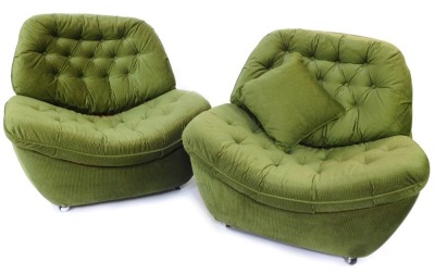 A pair of retro egg shaped chairs, in green cord material, with cushion back and seat, on castors, 89cm high, 94cm wide, 80cm deep. The upholstery in this lot does not comply with the 1988 (Fire & Fire Furnishing) Regulations, unless sold to a known expor