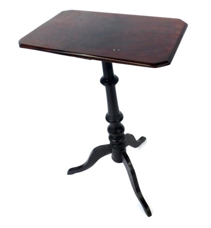 An early 20thC mahogany table, the rectangular top with canted corners on a turned column and tripod base, 70cm high, 28cm wide, 46cm deep.