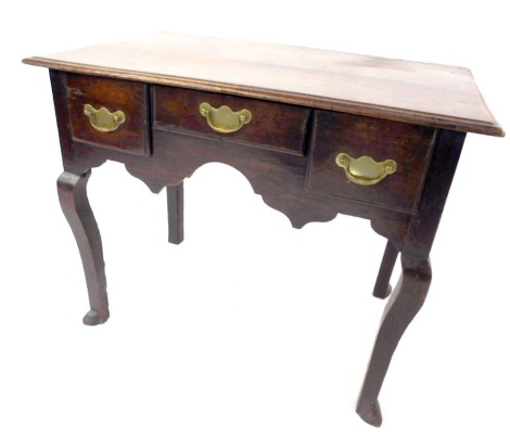 A 19thC oak lowboy, the two planked top above arrangement of three drawers, with shaped apron and cabriole legs, 72cm high, 88cm wide, 54cm deep.