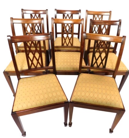 A set of eight mahogany dining chairs, each with cross hatched panel back, on square tapering legs, 90cm high, 47cm wide, 42cm deep. The upholstery in this lot does not comply with the 1988 (Fire & Fire Furnishing) Regulations, unless sold to a known exp