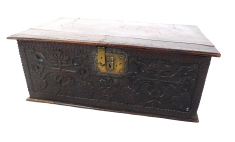 A late 17th/early 18thC oak bible box, the carved top and front with flower and leaf design, later brass lock plate, 24cm high, 62cm wide, 37cm deep.