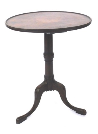 A 19thC oak and mahogany table, with circular dished top on a turned column with tripod base, 71cm high, 48cm diameter.