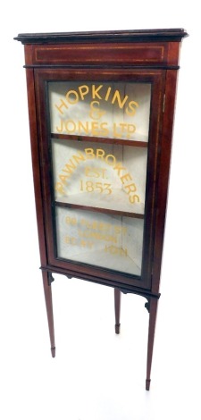 An Edwardian corner display cabinet, with satinwood banding, and painted mirror glass, Hopkins and Jones Ltd, Pawnbrokers Estd 1853, 88 Fleet Street, London., on taper legs, 140cm high, 55cm wide, 32cm deep.