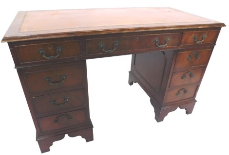 A reproduction mahogany pedestal desk, the top with tan leather inlay above nine drawers, on bracket feet, 47cm high, 117m wide, 60cm deep.