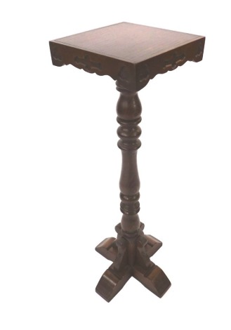 An early 20thC oak bible stand, the square top with carved sides, with leaf clover moulding, on a four strand column base, 92cm high, the top 27cm x 27cm.