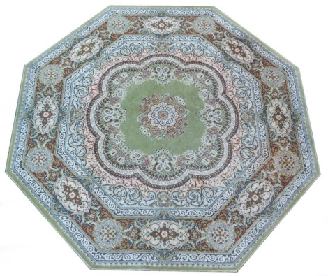 An Eastern octagonal rug, on a light green ground with floral centre and outer border, 245cm diameter.