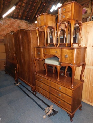 A John W Talton walnut bedroom suite, comprising double bed frame, including head board, foot board and two metal supports, two two door wardrobes with fitted drawer and shelf interior, 198cm high, 123cm wide, 60cm deep and two three drawer bedsides on o