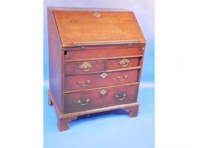 An early 18thC oak bureau with fall flap revealing a well interior