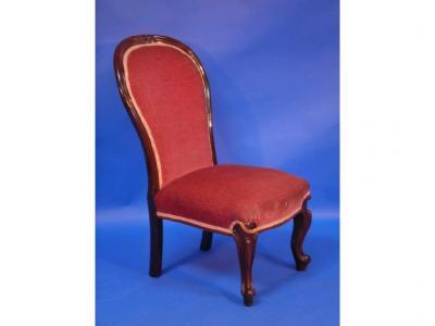 A Victorian rosewood spoonback nursing chair with scroll legs
