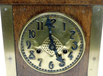 An early 20thC Art Nouveau oak and brass cased mantel clock for Liberty and Co, circular brass dial bearing Arabic numerals, German Hamburg American Clock Movement eight day movement with exposed bell strike, the case of arched and out swept form, with an - 2