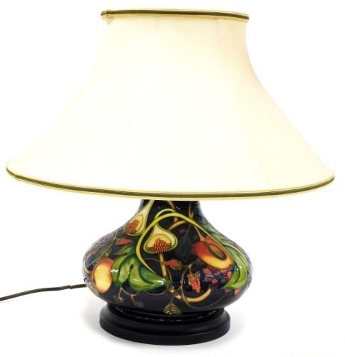 A Moorcroft pottery Queen's Choice table lamp, of compressed out swept form, with shade, 46cm high including shade.