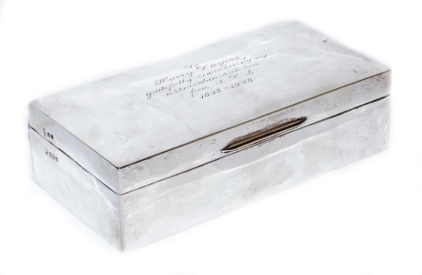 A George V silver cigarette box, of rectangular form, bearing inscription 'To Harry Fayers gratefully remembering my association with him from SRL 1895-1928,' London 1928, with treen lined interior, 17cm wide.