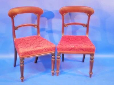 A pair of Victorian mahogany balloon back dining chairs with reeded forelegs