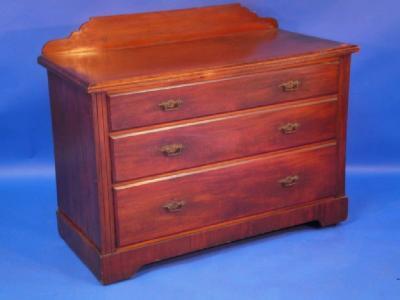 A late Victorian walnut chest of drawers with moulded top