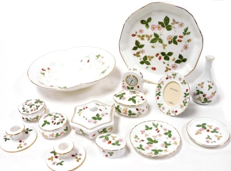 Wedgwood dressing table items decorated in the Wild Strawberry pattern, including pots and covers, vase, pair of chamber sticks, together with two dishes. (a quantity)