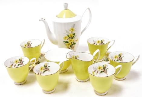 A Royal Albert porcelain part coffee service, decorated with yellow primroses, comprising coffee pot, cream jug, sugar bowl, six cups and saucers.