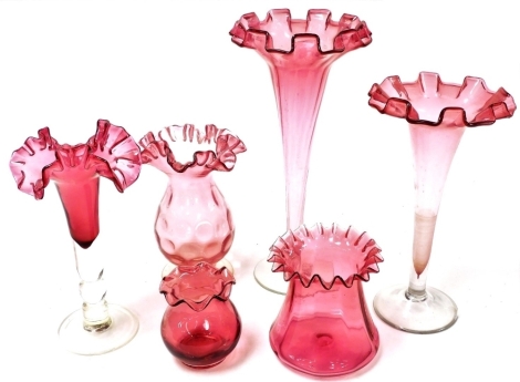 A group of Victorian and later cranberry glass, comprising three trumpet shaped vases and three further vases. (6)