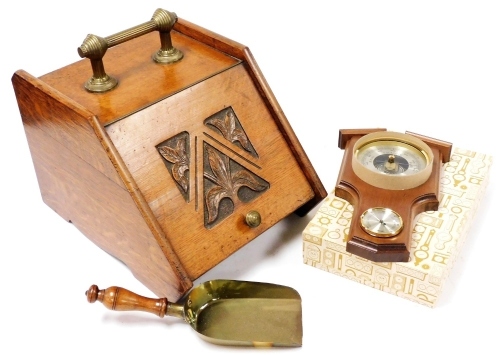 A late Victorian oak coal box, the hinged lid with carved leaf decoration, brass handle and brass scoop with turned treen handle, 45cm wide, and an oak cased wall barometer, boxed.