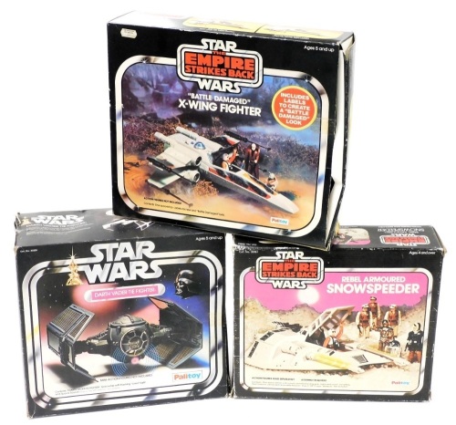 A group of Star Wars boxed toys; Battle Damaged X-Wing Fighter, Rebel Armor Snowspeeder and Darth Vader The Fighter. (3)