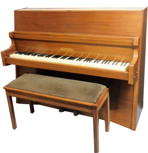 A Bentley mahogany overstrung upright piano, with Rensonoura soundboard with concave front and shaped sides.