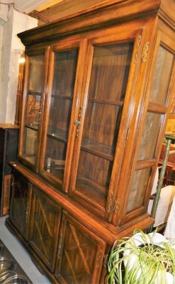 A hardwood display cabinet, the top with two glazed doors, the base with three panelled doors, 193cm high, 150cm wide, 43cm deep.