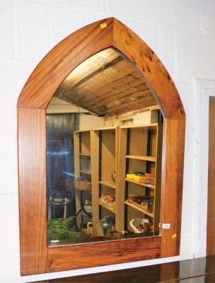 A modern yew arched wall mirror.