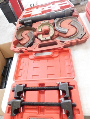 A strut spring compressor kit and Macpherson strut spring compressor. (2)