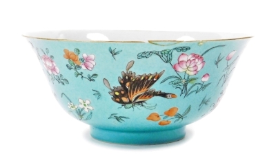 A 19thC Chinese porcelain bowl, the sgraffito turquoise ground incised with repeating scrolls and enamelled with polychromed butterflies, flora and fruits, 22cm diameter, 10cm high. (AF)