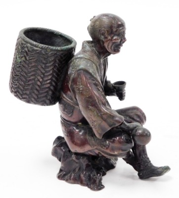 A Japanese bronze figure, Meiji period, modelled in the form of a man holding a gourd and a cup, whilst carrying a basket, unsigned, 17cm high. (AF) - 5