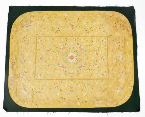 A Chinese Imperial yellow ground rectangular silk throne seat cover, finely embroidered in blue, orange, brown, green, cream, etc. with plants including, fungus, peonies, bamboo, prunus, pine around a central peony. Later cloth backing, Qianlong period, 1