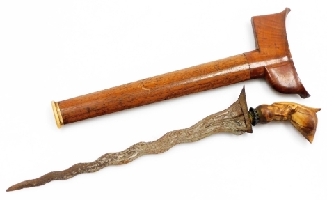 A Javanese kris, with a watered steel blade and carved bone hilt in the form of an animal, with a hardwood sheath, 36cm long overall.