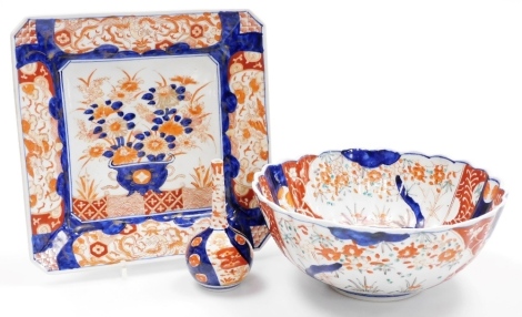 A Japanese Imari fluted bowl, 24cm diameter, an Imari square shaped dish with vase of flowers, 25cm wide, and a long necked bottled vase, Meiji period, 13cm high.