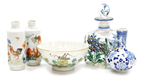 Two Chinese porcelain snuff bottles, decorated with Shubunkin and cockerels, 7.7cm and 8cm high, a small Chinese doucai bowl decorated with grasshoppers and flowers, 8cm high, a glass scent bottle and a small blue and white vase. (5)