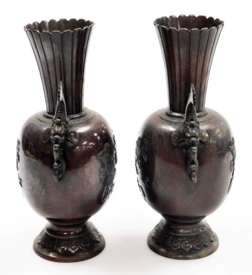 A pair of Meiji period Chinese bronze vases, with flared fluted necks and flowering branch and bird decoration in relief, fish handles and lappet decoration to the foot, 27.5cm high. - 4