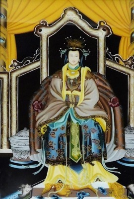 A 20thC Chinese ancestor portrait on glass, depicting a high ranking woman in a seated pose, with hardwood frame, 47cm x 30cm.
