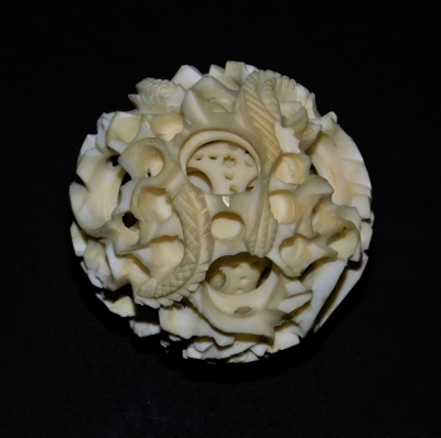 A Chinese early 20thC ivory puzzle ball on stand, with concentric balls, the outer ball carved with a dragon, 11cm high, the ball 4cm dimater. - 7