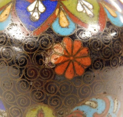 A Chinese brass and champleve enamelled box, of butterfly form, the wings decorated with flowers, 9cm wide, together with a pair of Japanese Meiji period cloisonne enamel vases, decorated with roundels of flowers and other symbols, against a black ground, - 12